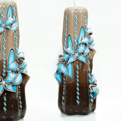 Handmade carved candle showcasing blue flower design
