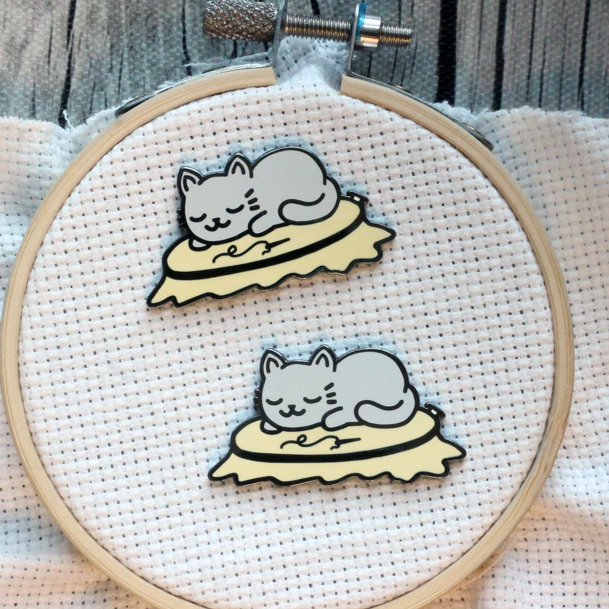 Cat in embroidery hoop needle minder showing magnetic backer