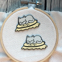 Cat in embroidery hoop needle minder showing magnetic backer