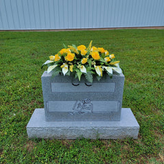 Silk grave flowers arrangement on saddle
