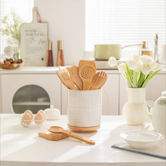 white ceramic utensil holder with cork base for countertop