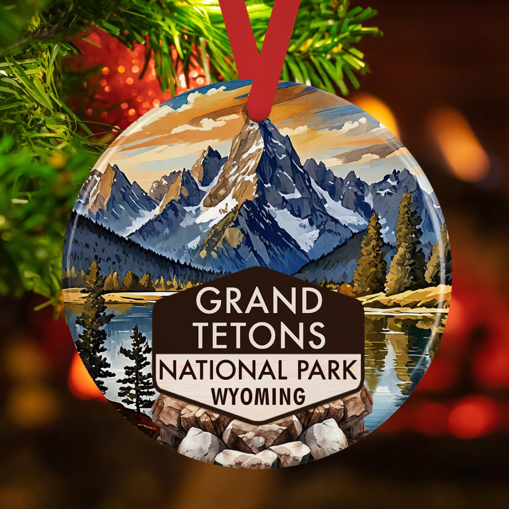 Glossy round ceramic ornament displaying alpine peaks and lake