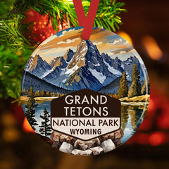 Glossy round ceramic ornament displaying alpine peaks and lake