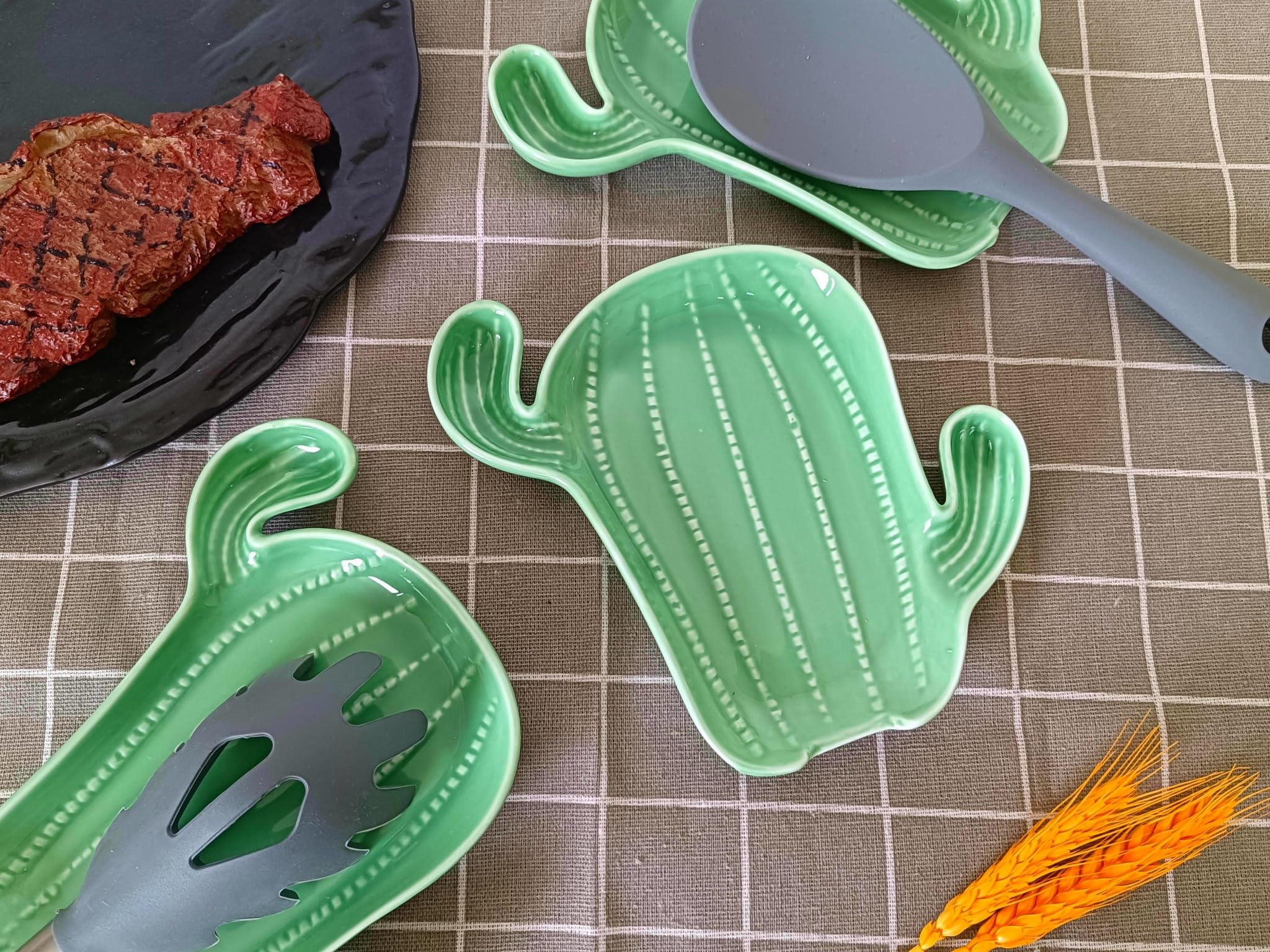 Ceramic spoon rest for kitchen counter featuring green cactus motif