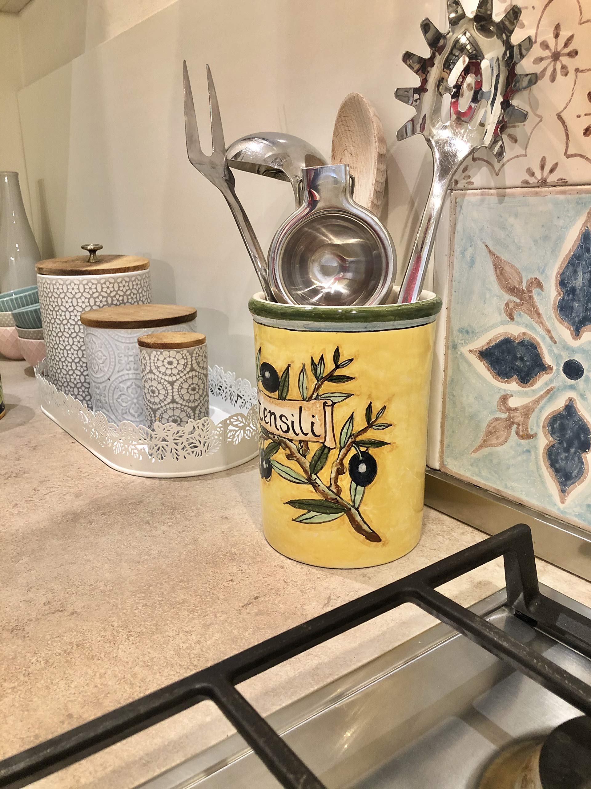 Italian ceramic utensil holder vessel olives yellow background