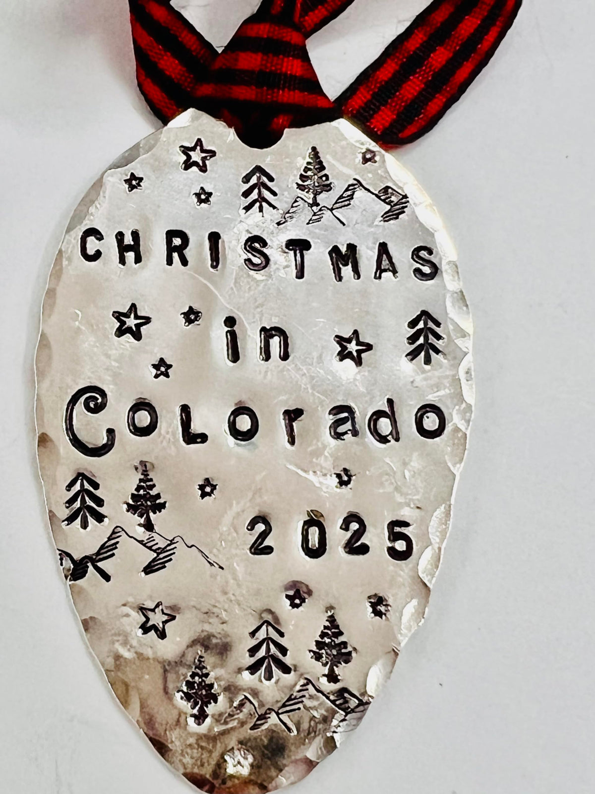 Mountains and stars design on a hand stamped spoon ornament