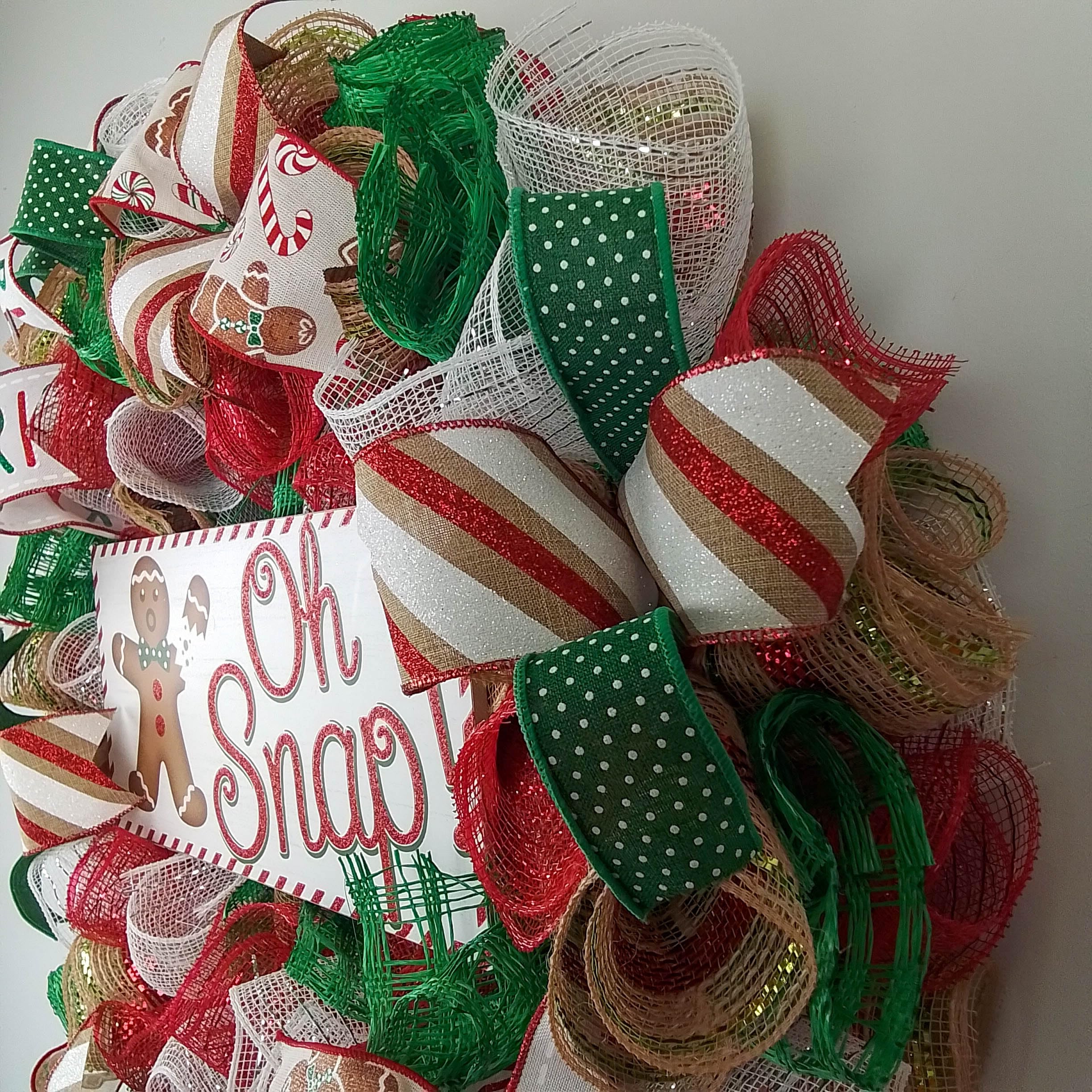 Coordinating ribbons accent Gingerbread sign on wreath