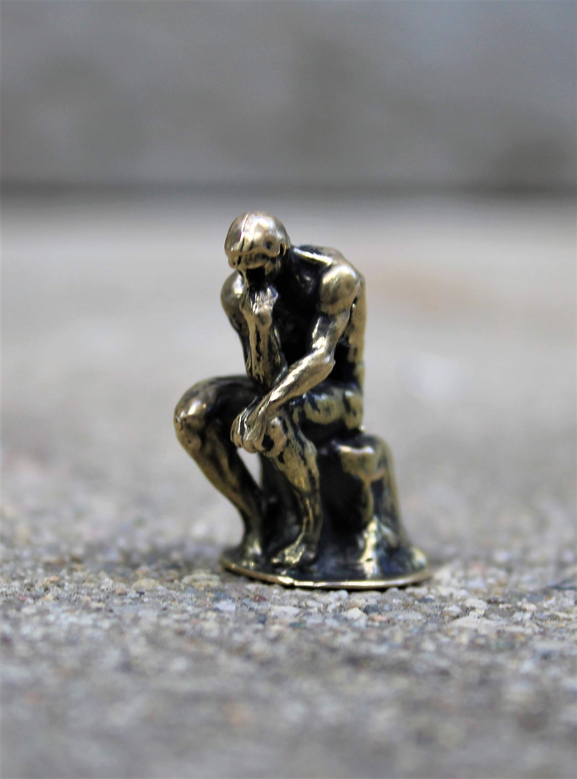 Classic brass Thinker sculpture displayed