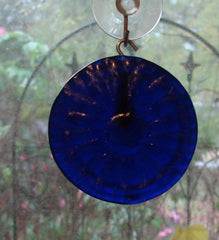 Circular cobalt blue glass ornament from bottle bottom