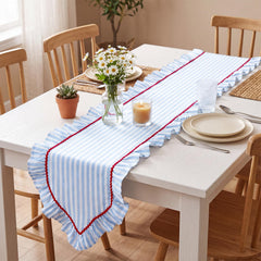 Red serrated lace accent on striped table runner