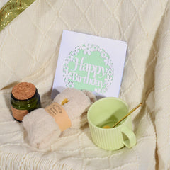 Cozy blanket and fuzzy socks close up from birthday gift set