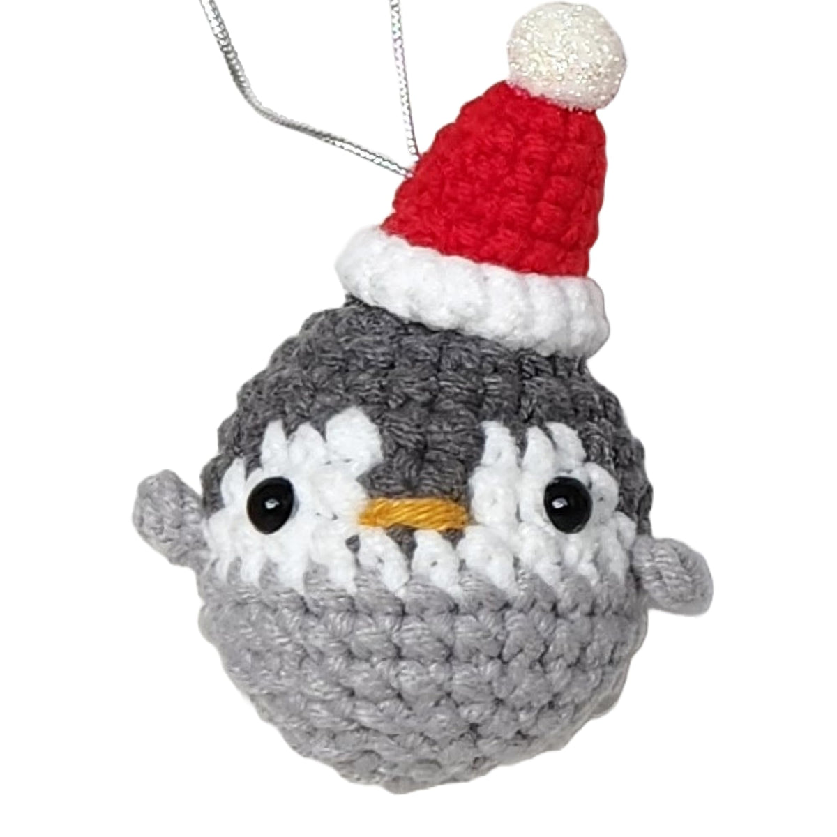 Crochet Santa Penguin ornament hanging on Christmas tree