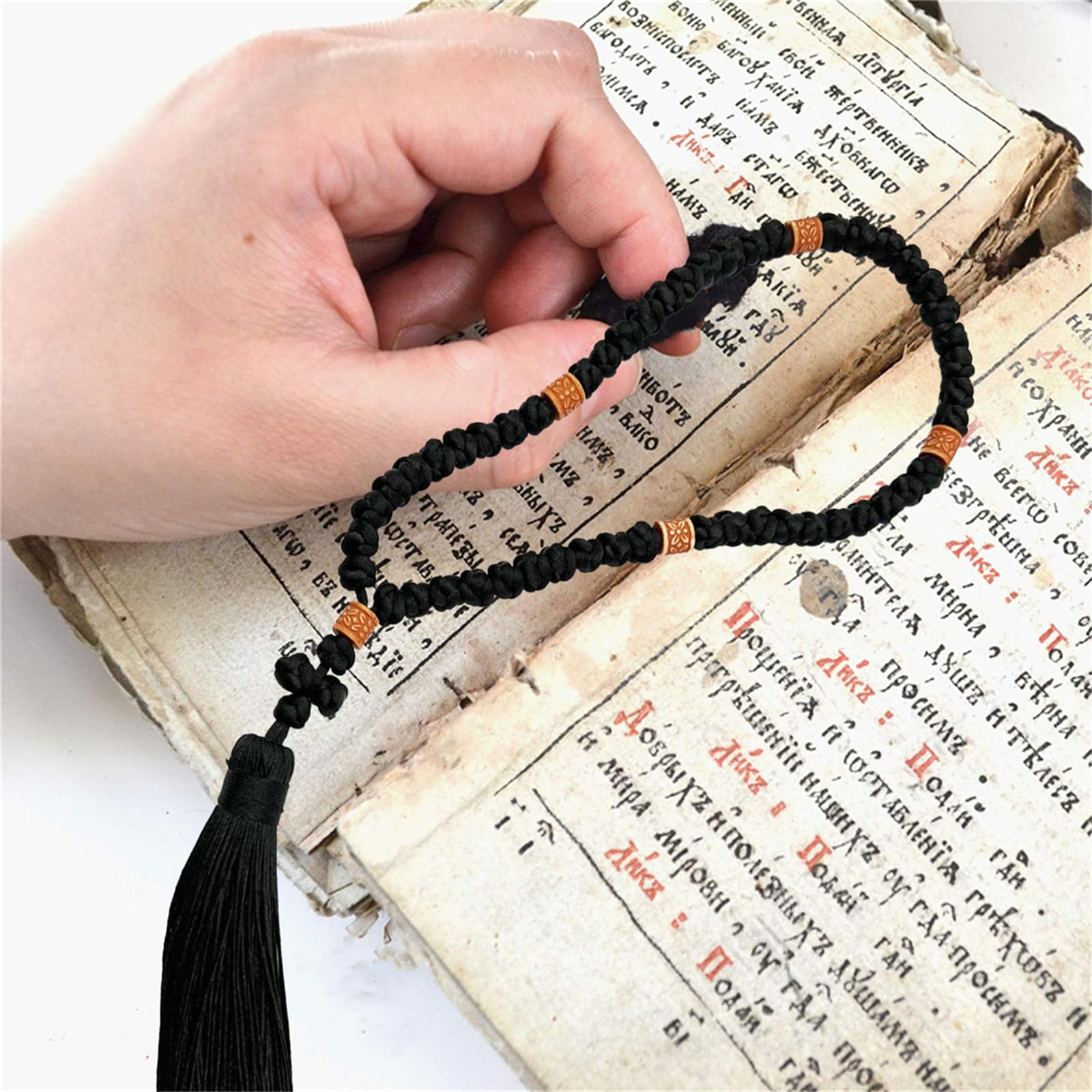Cross charm on prayer rope for Orthodox devotion