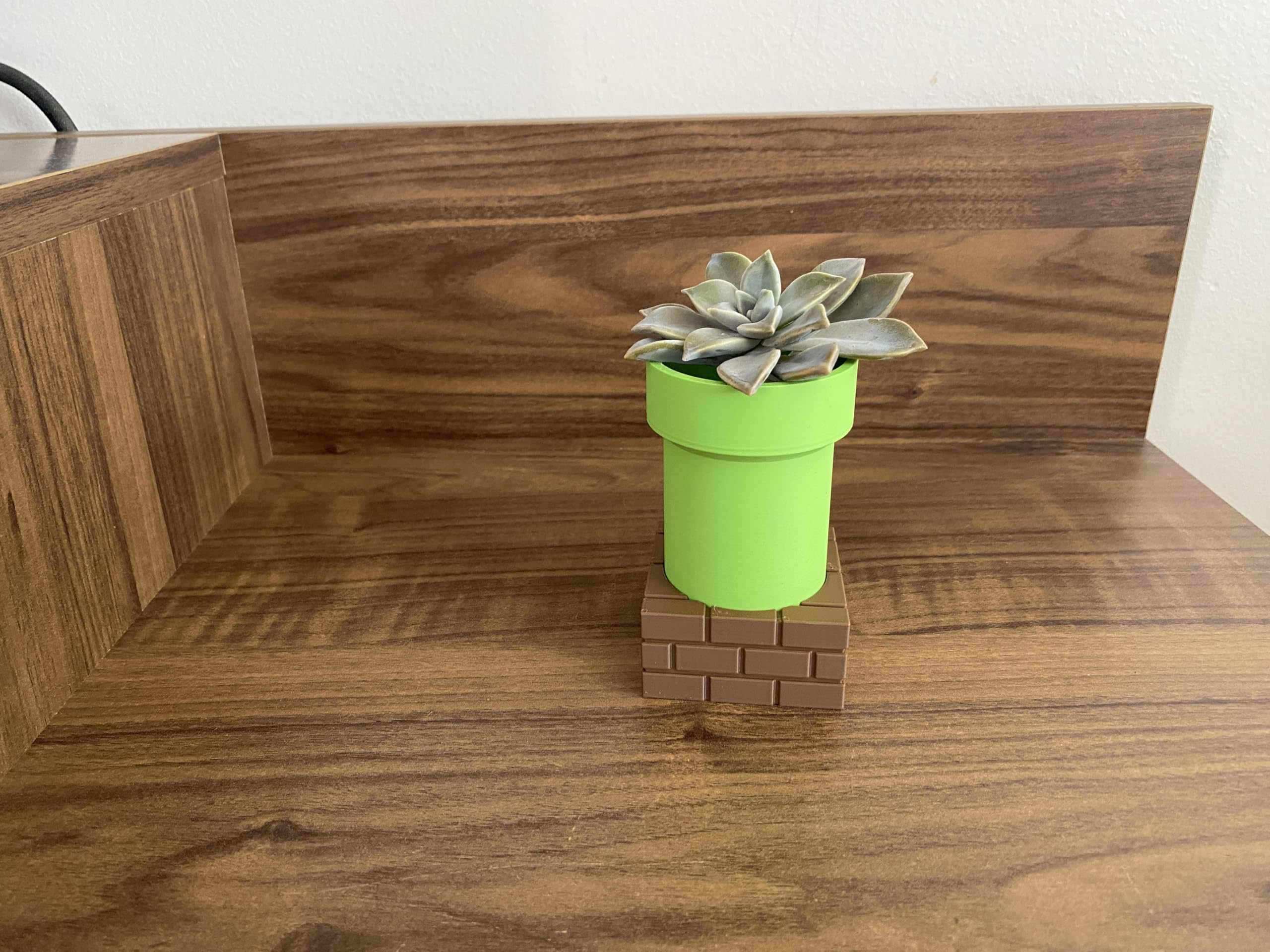 Planter shown as desk decor on a shelf