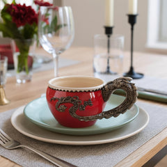 Dragon handle mug showing floral scale detailing and blush interior