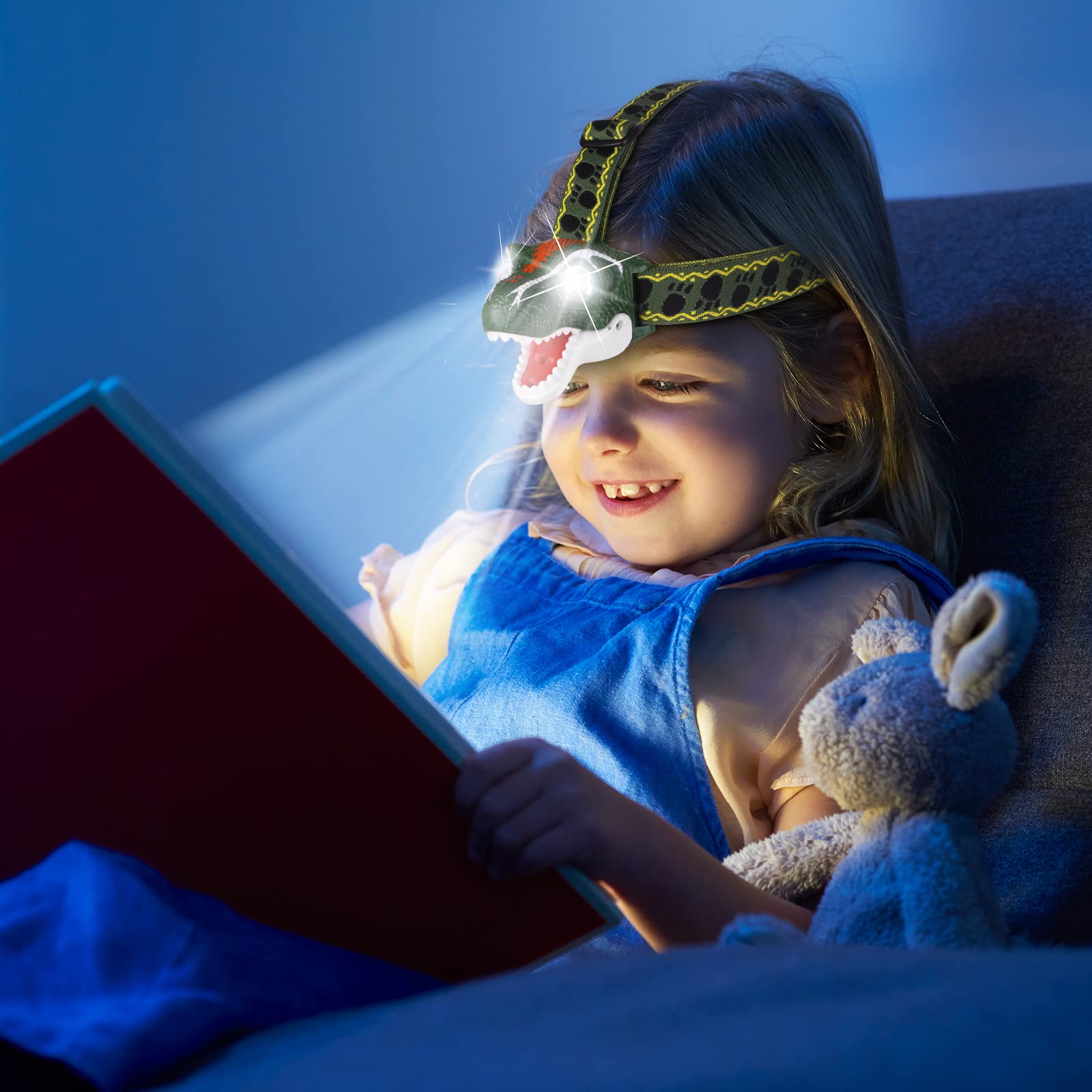 Child wearing DX DA XIN dinosaur headlamp during camping