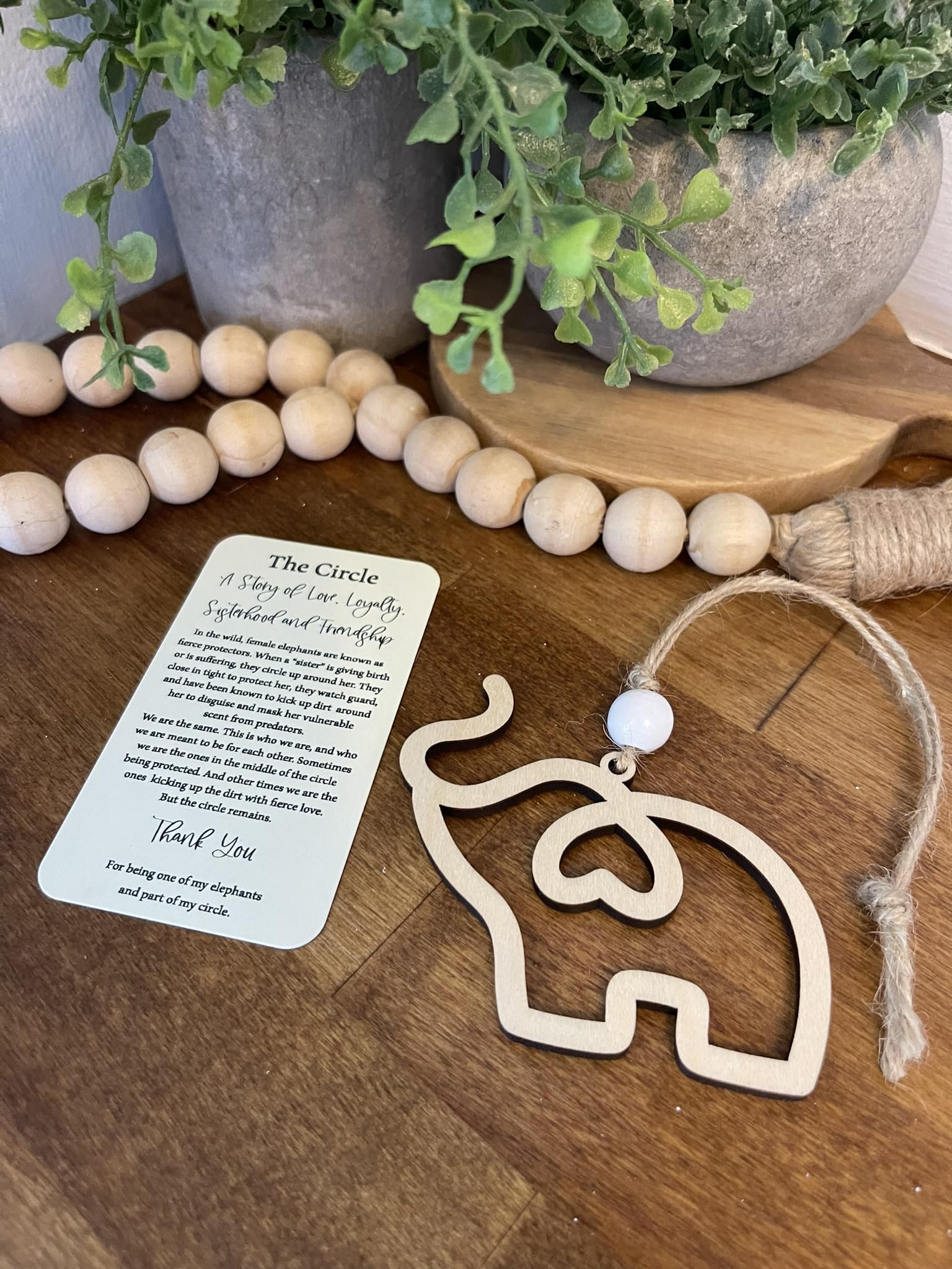 Elephant ornament with white bead and juke twine string