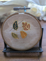 Mini magnetic needle minder shown on an embroidery hoop