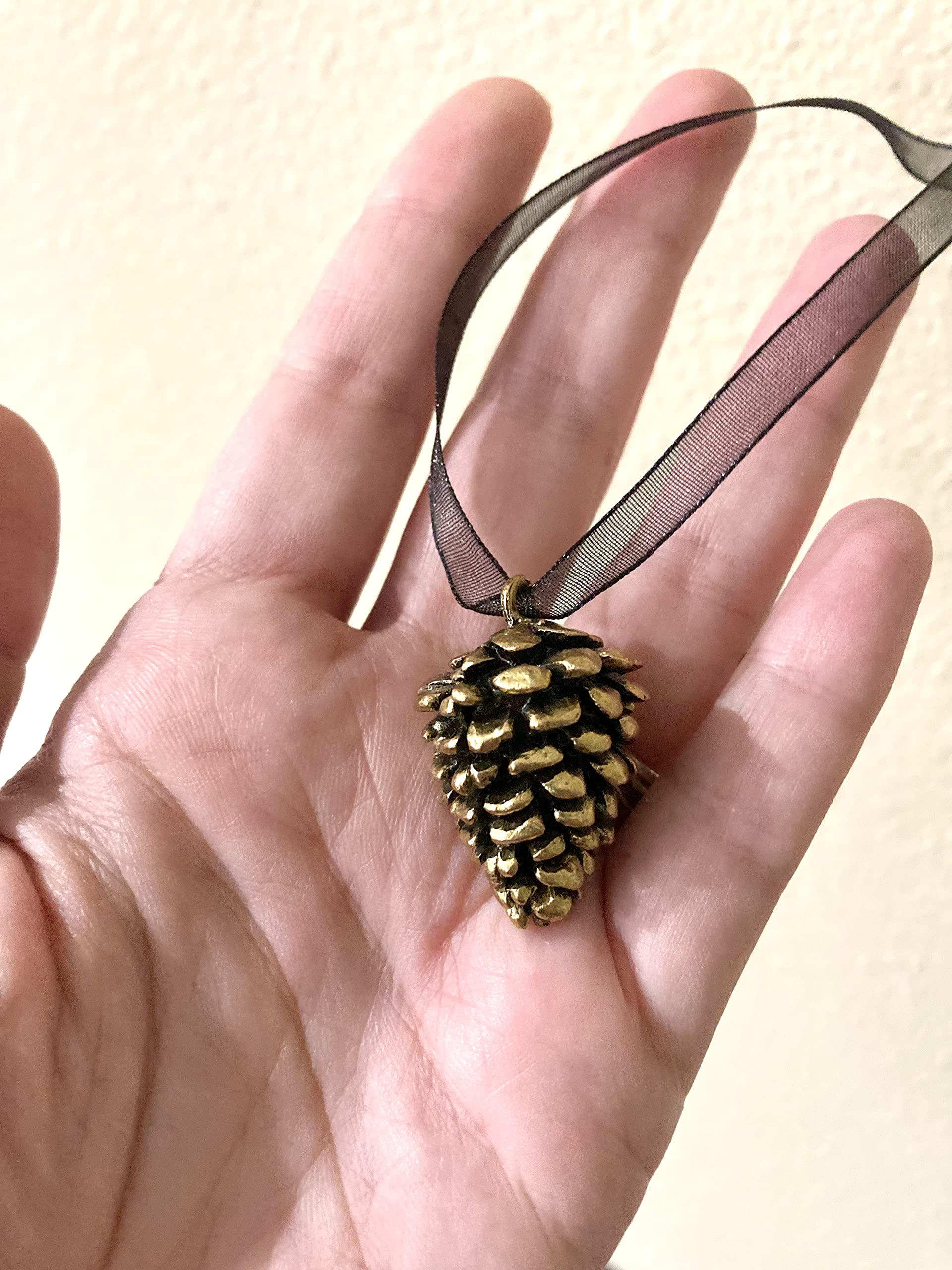 Antiqued brass pine cone ornament with thick weight