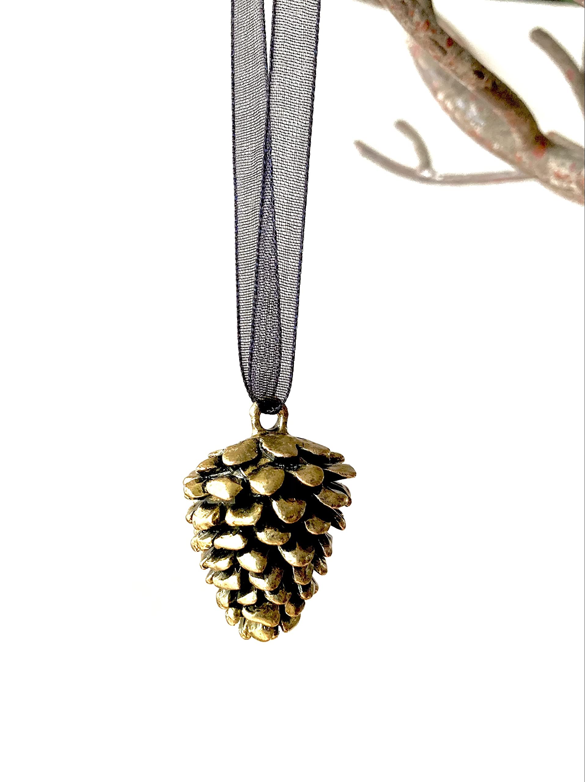 Strung on a black ribbon for hanging