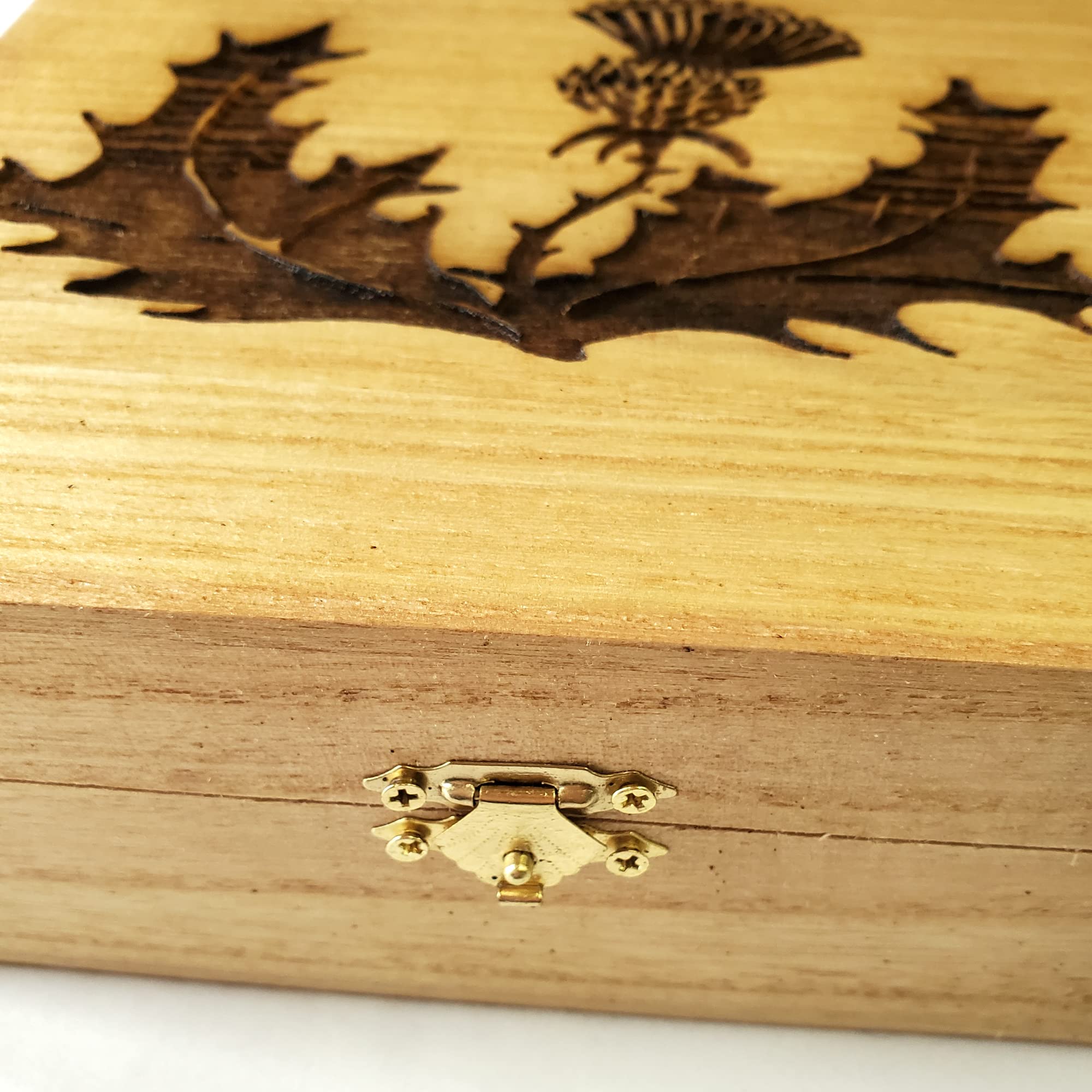 Engraved Scottish thistle design on wooden box
