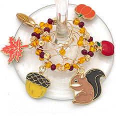 Six silver fall wine glass charms attached to stems