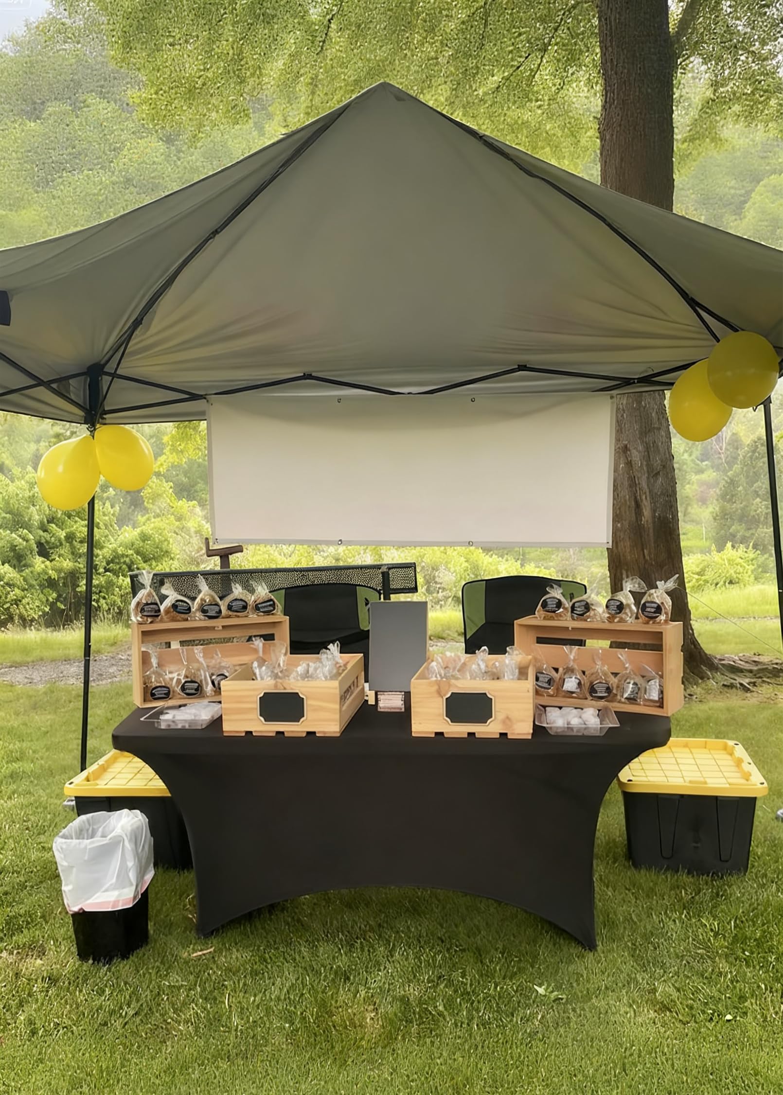folding tables covered with black tablecloths outdoors