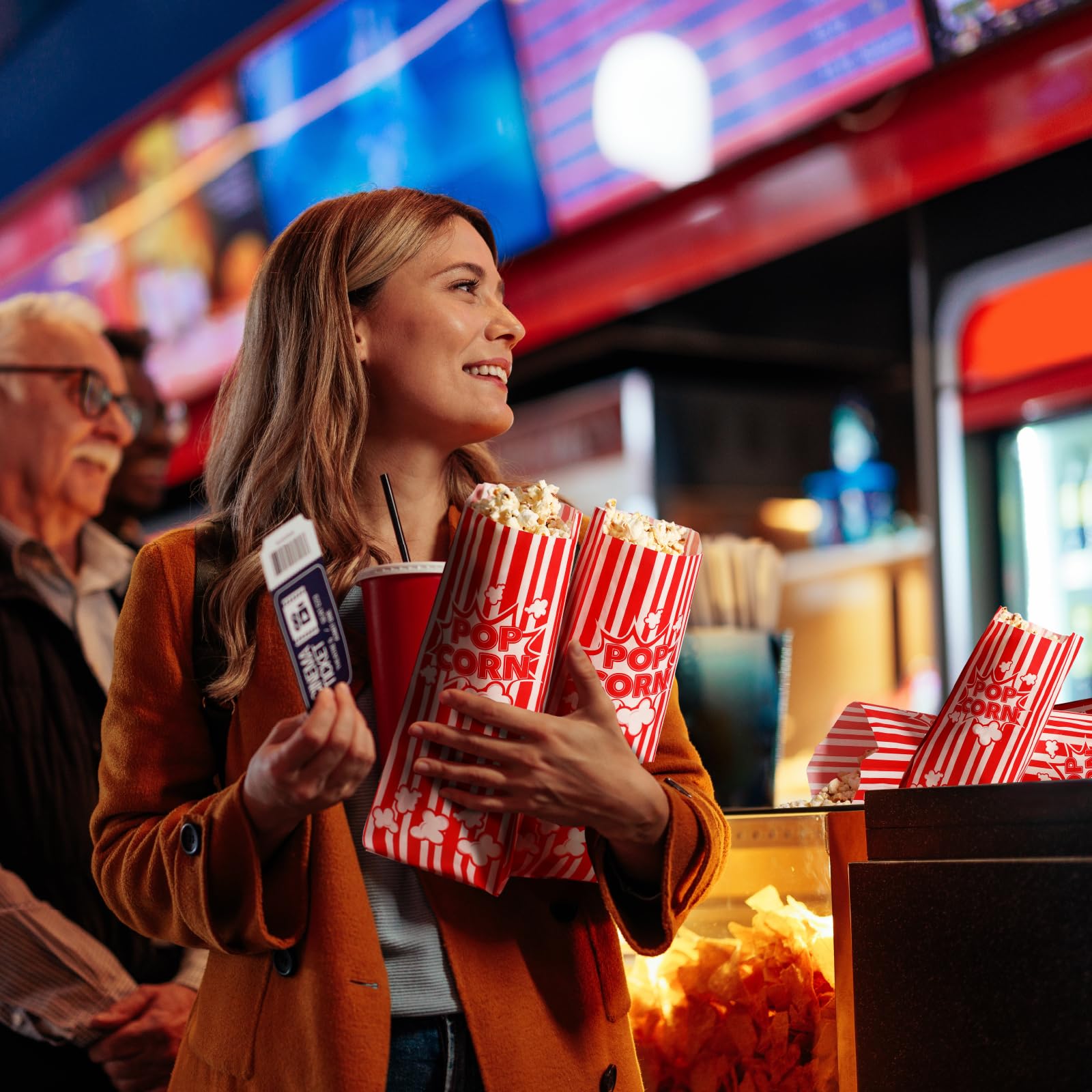 Folded flat popcorn bags for easy storage near machine
