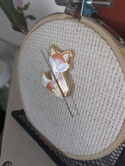 Needle held in place on fabric by Forest Fox Needle Minder