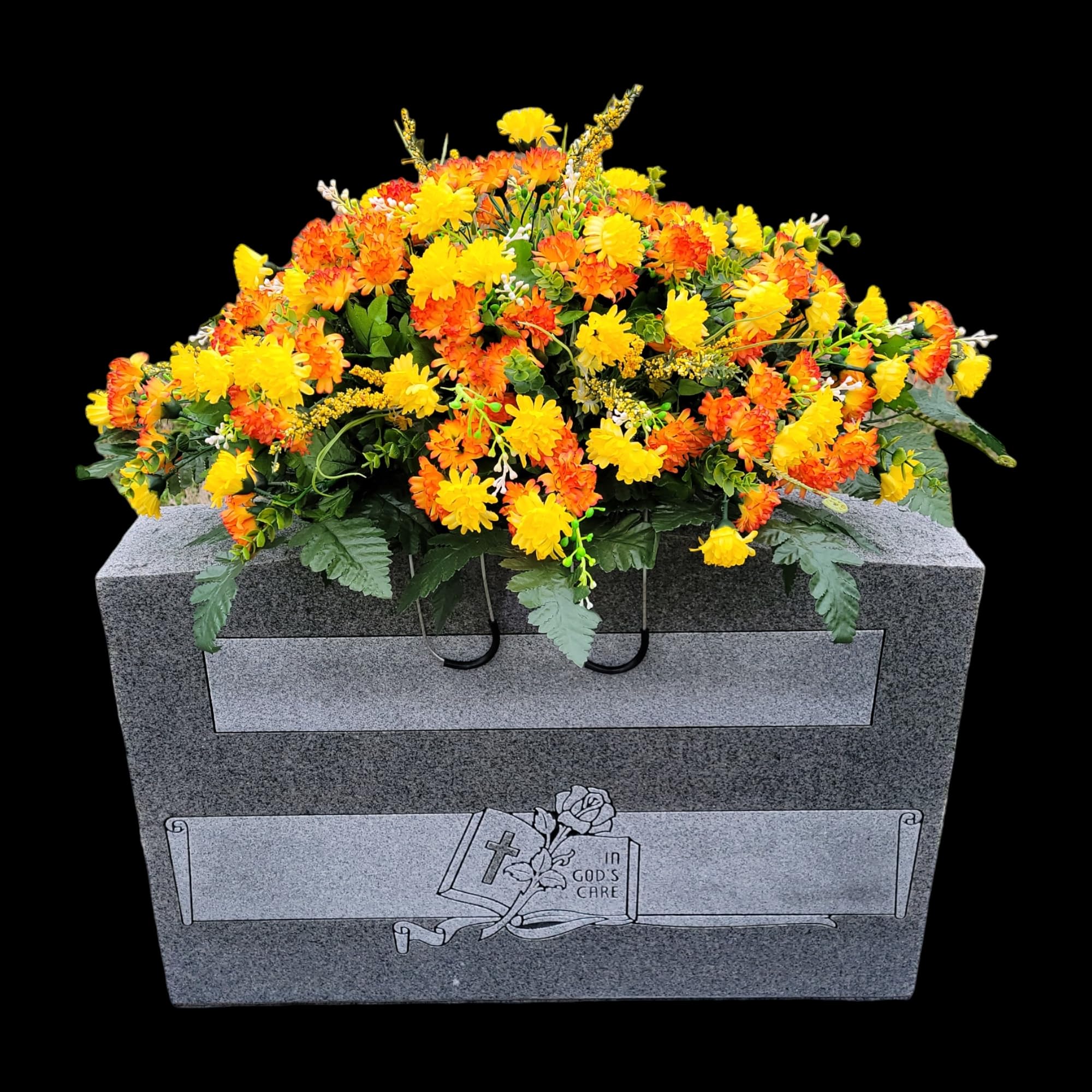 Mini mums with greenery arranged on a headstone saddle