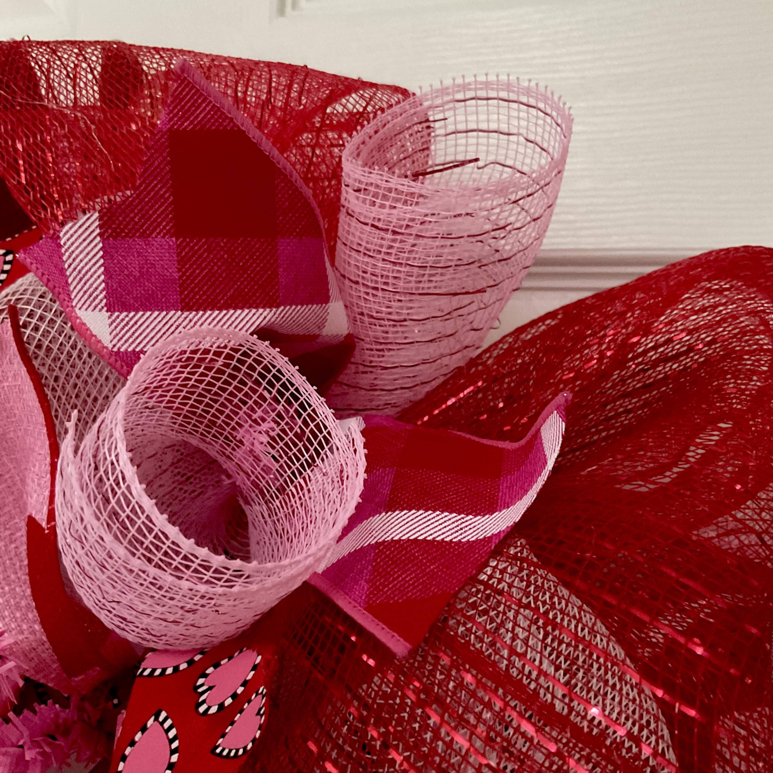 Front door decor wreath with pink and red heart ribbons