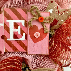 Closeup of pink deco mesh and button accents on Love Block Letters wreath