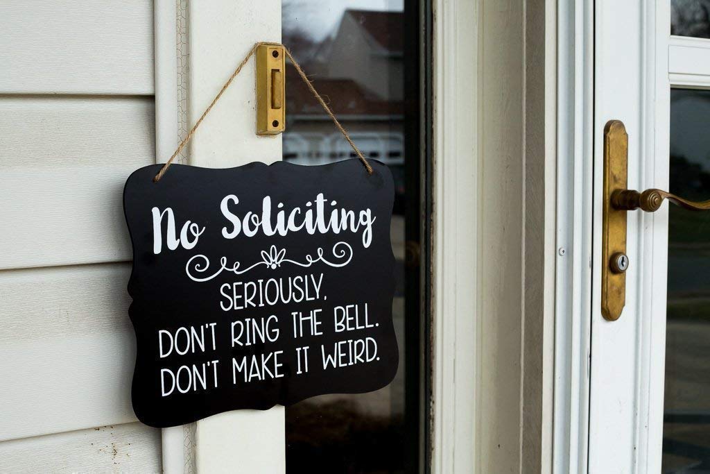 Sign with hanging string for easy installation No Soliciting Sign