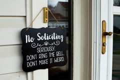 Sign with hanging string for easy installation No Soliciting Sign