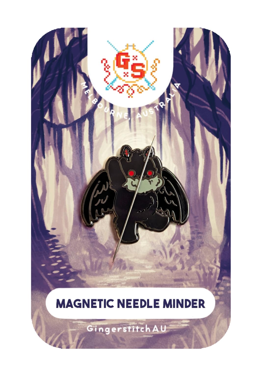Mothman Needle Minder magnetic back magnet attached to cross stitch fabric on 14ct Aida