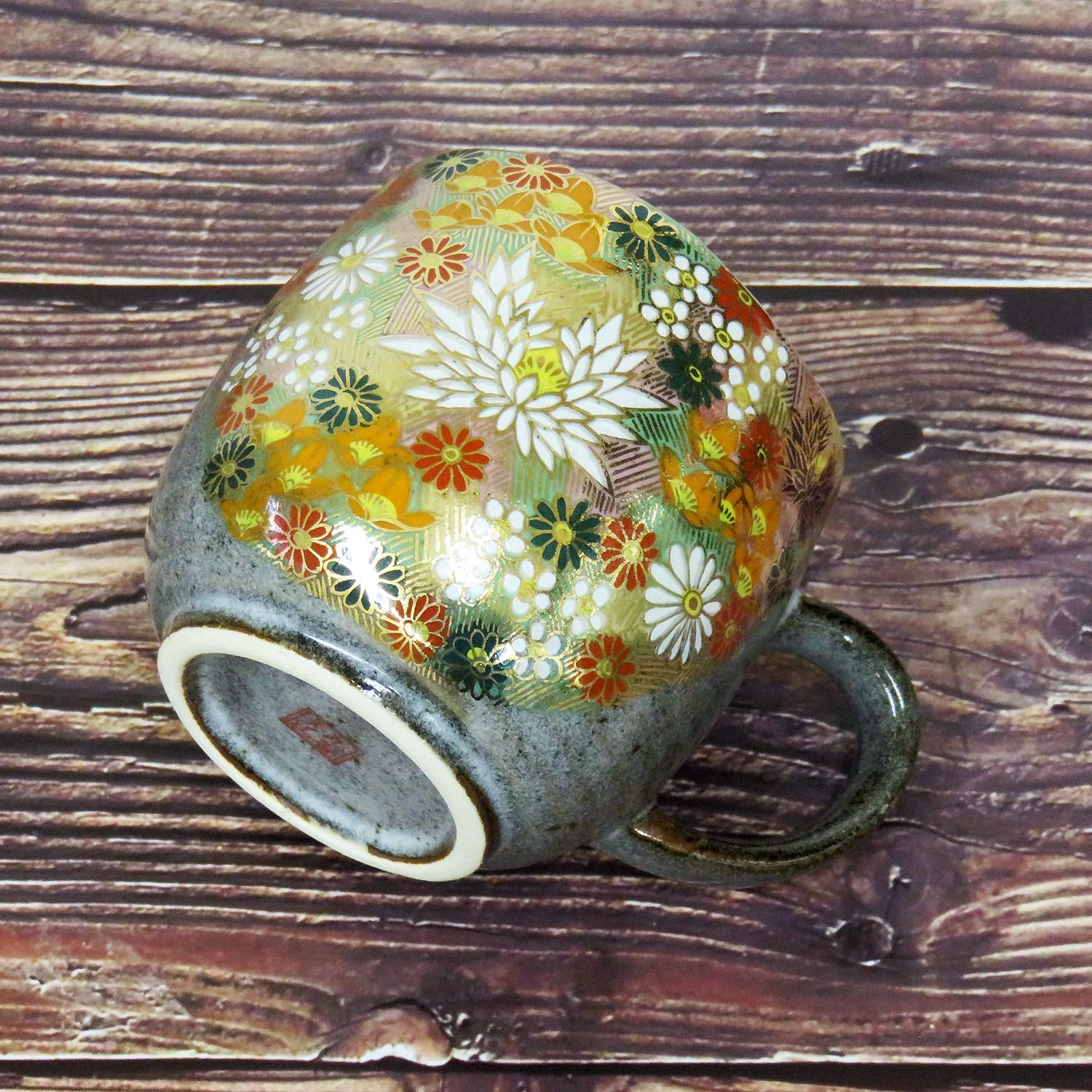 Close-up of gold floral pattern on porcelain mug