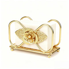 Gold napkin holder on table with floral pattern