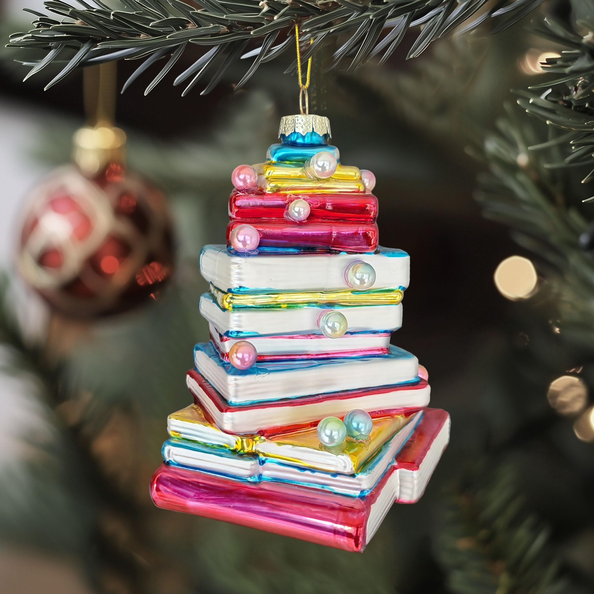 Gold string hanging on book shaped ornament
