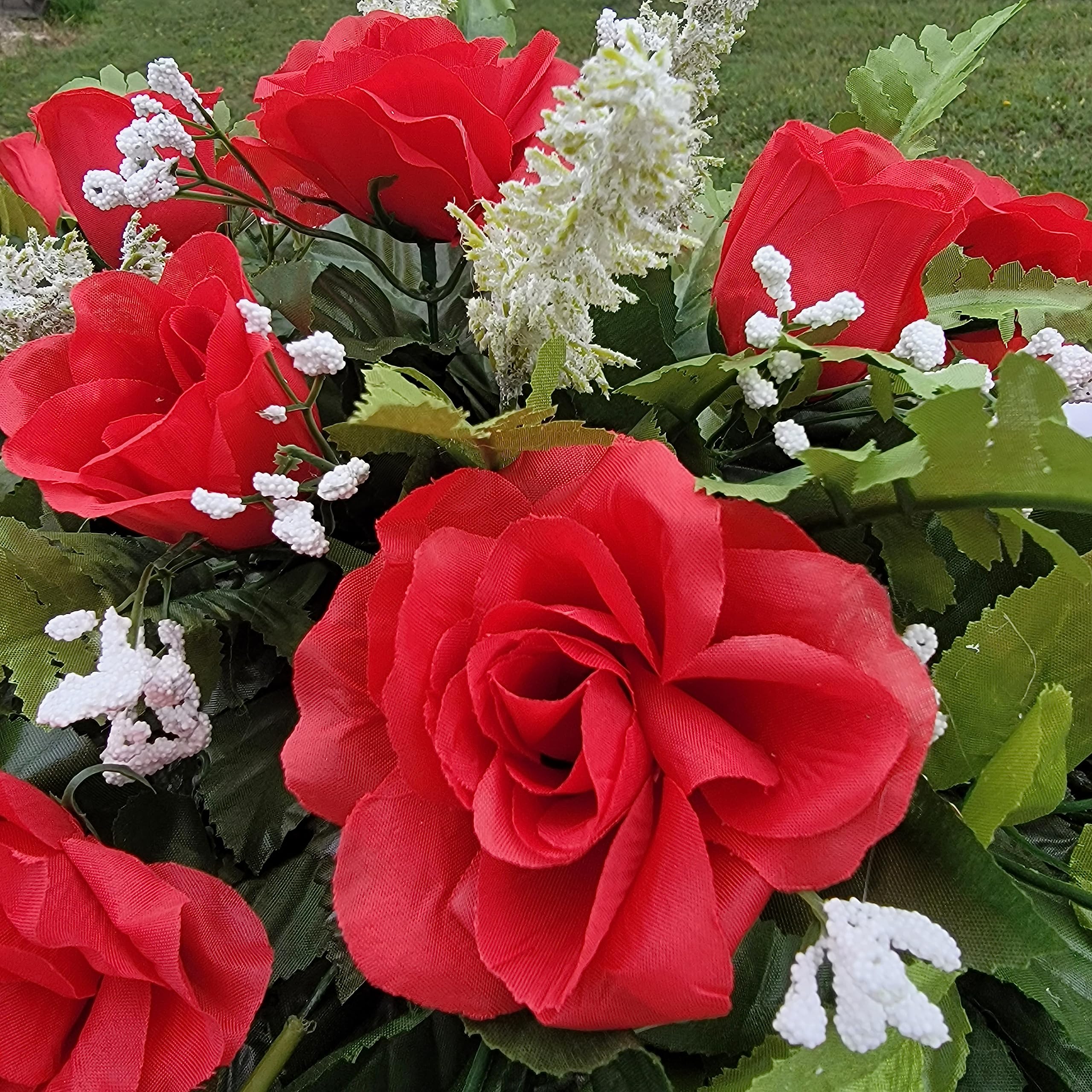 Grave site display showing red and white floral saddle decoration