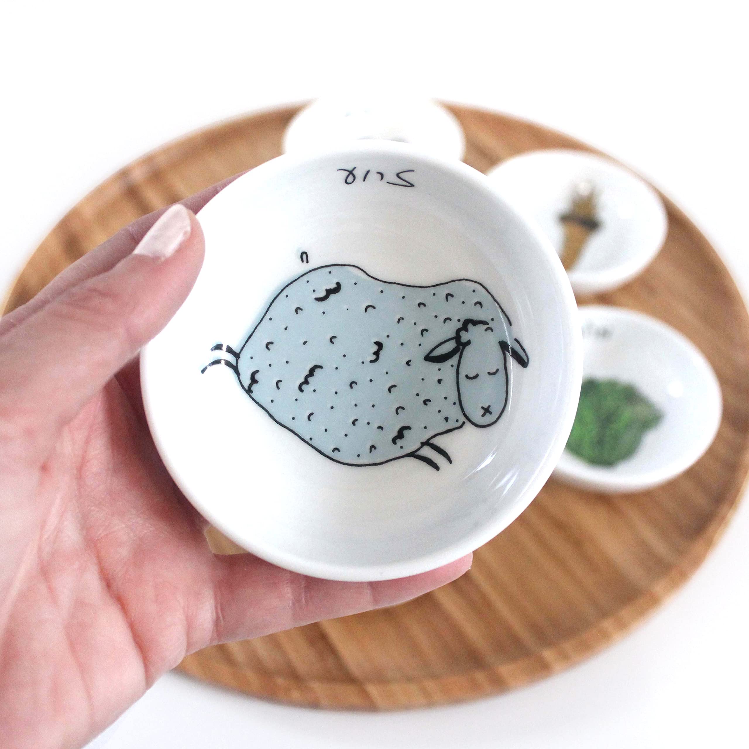 Hand-sketched illustrations on the bowls