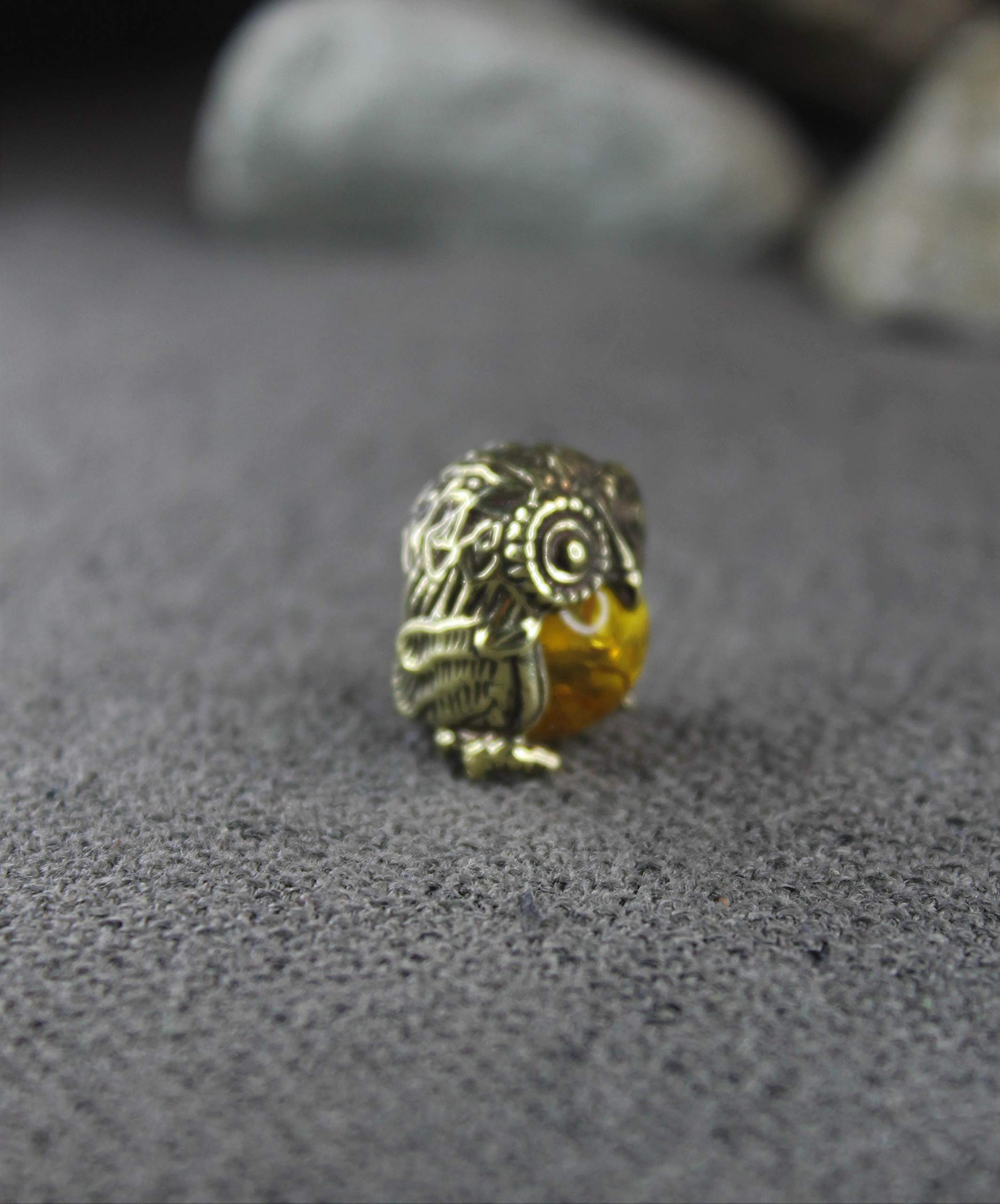Handmade brass owl displayed on desk