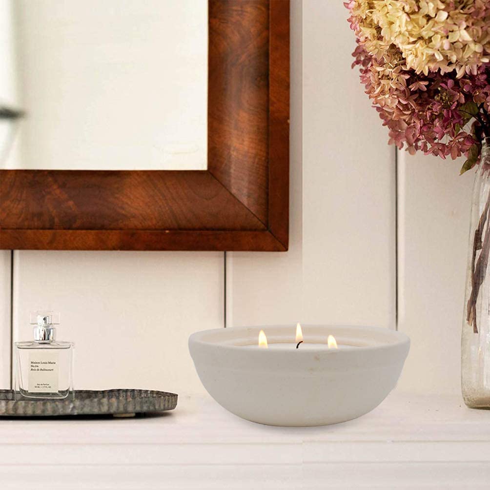 Natural citronella essential oil candle inside pottery vessel