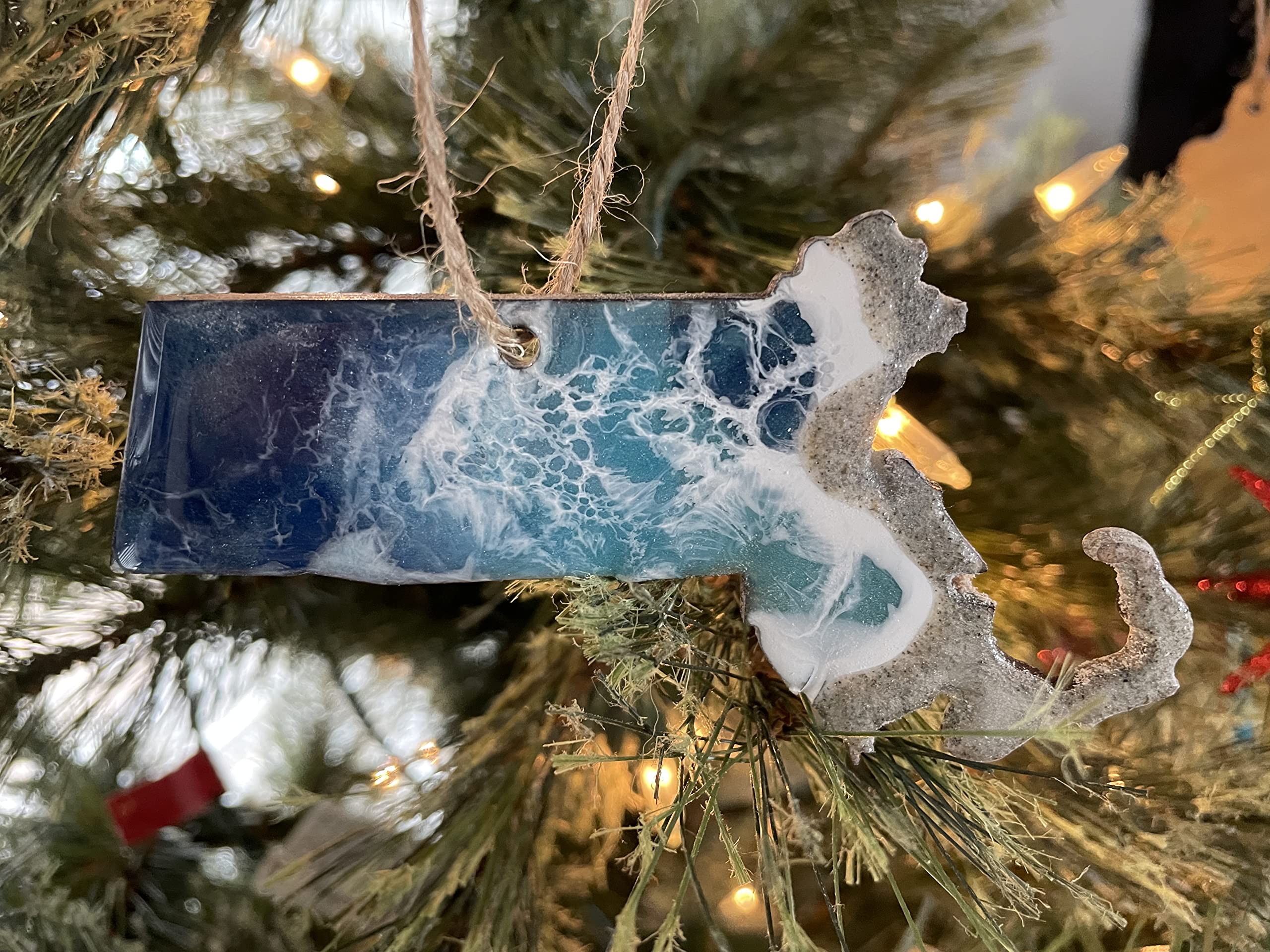 Back of ornament shows natural wood with minor discoloration