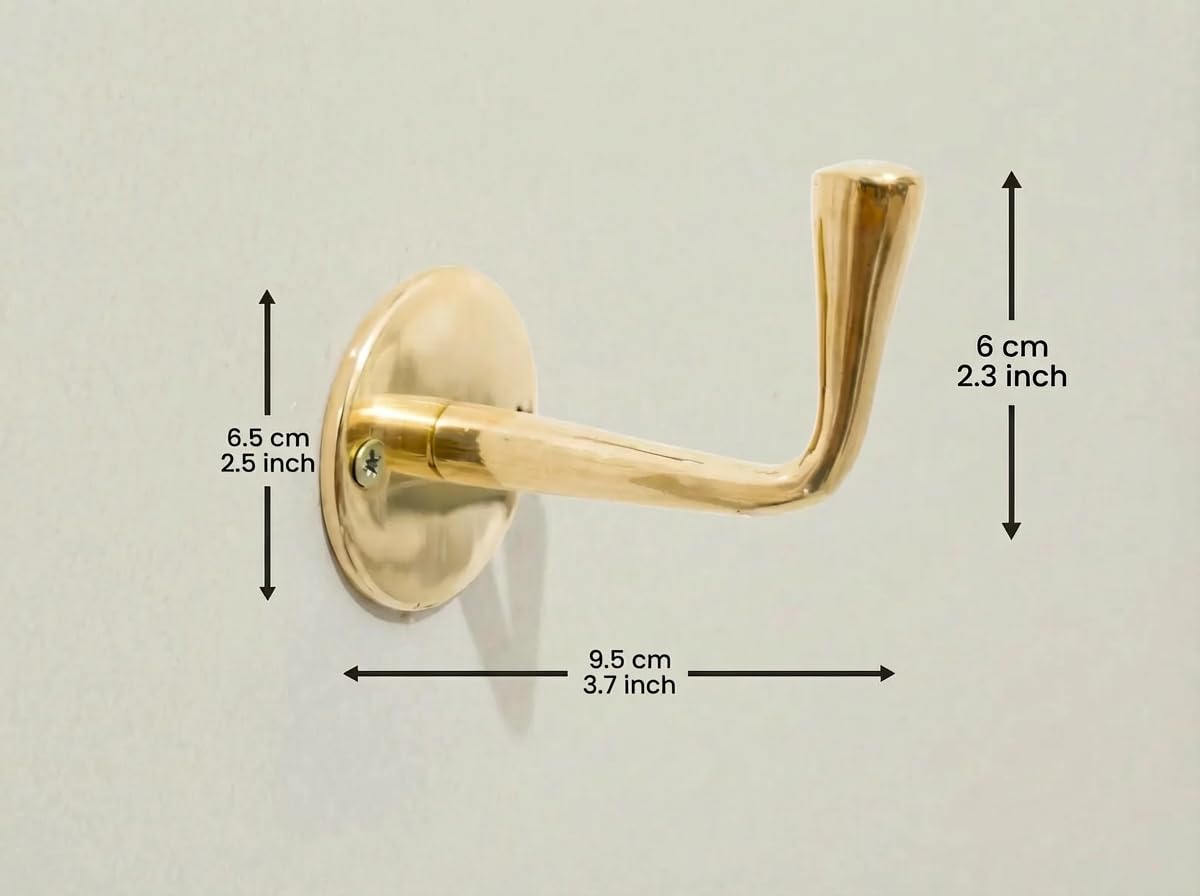 Vintage brass wall hook set on wall surface