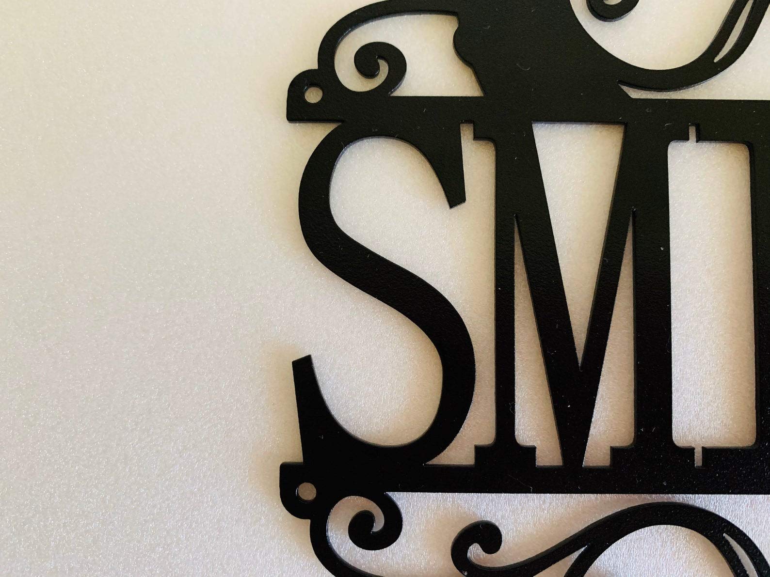 Hanging wall decor with metal monogram holes