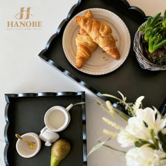 Hanobe coffee table tray displaying remotes candles and plants