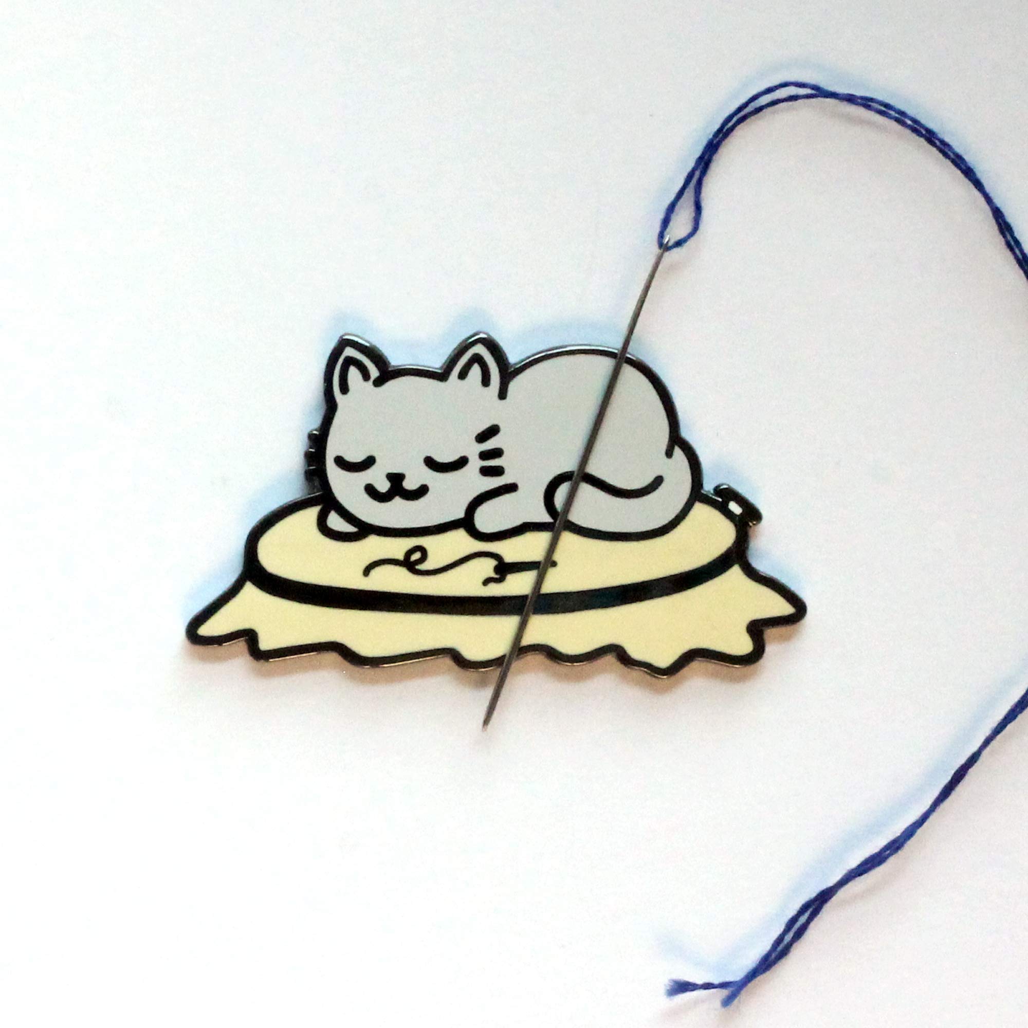 Hard enamel needle minder featuring a grey cat design