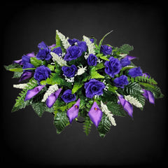 Handmade floral saddle by designers securing to grave marker