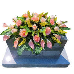 Headstone Flower Saddle with silk flowers on a grave marker