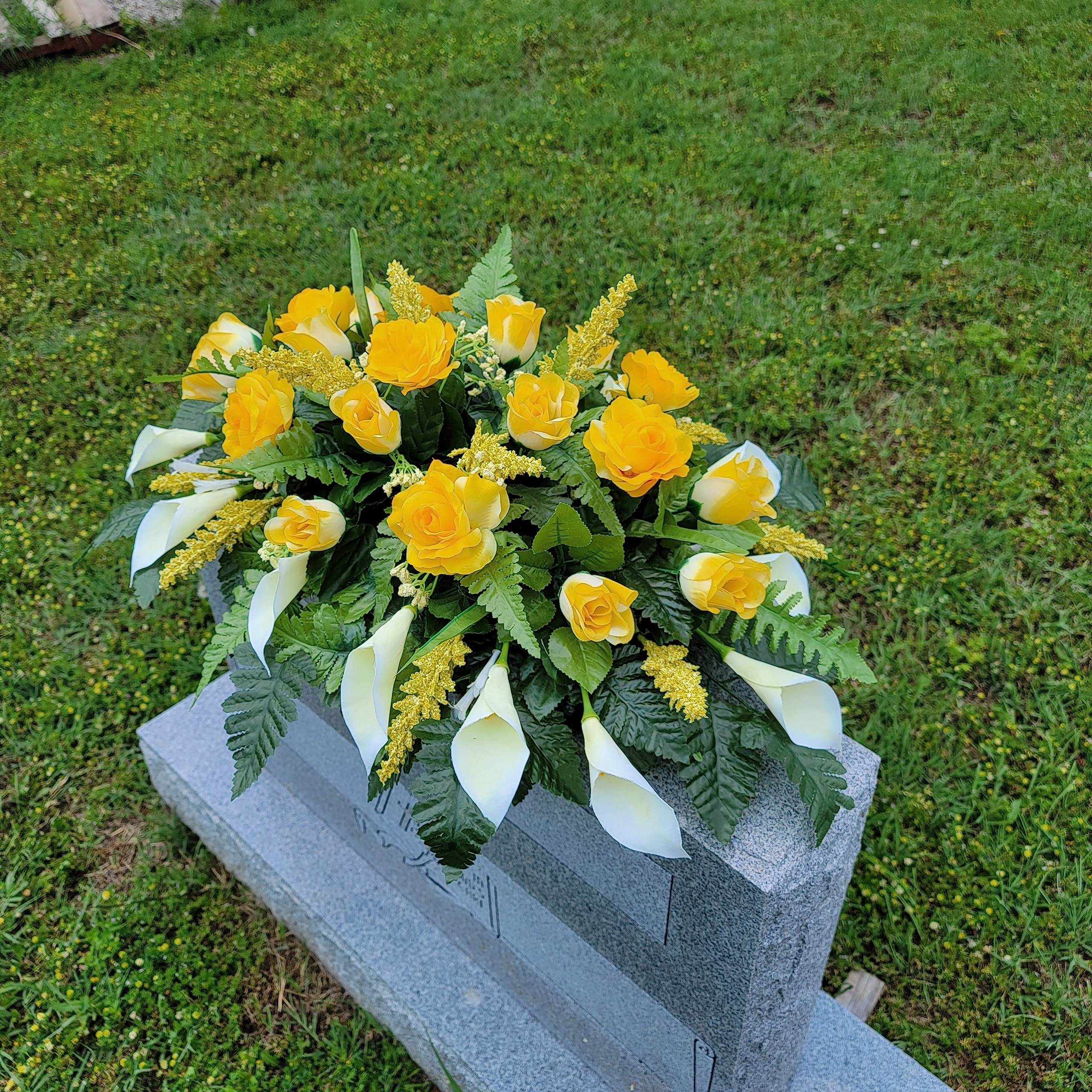 Headstone saddle featuring calla lilies and silk flowers